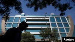 FILE - A man walks past India's Central Bureau of Investigation (CBI) headquarters building in New Delhi, India, March 6, 2018. 