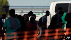 Migrants who crossed into the U.S. from Mexico are moved through a processing center on Sept. 21, 2023, in Eagle Pass, Texas.