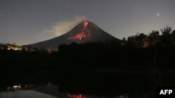 A long exposure photo shows Mount Merapi volcano releasing hot lava at the Srumbung village in Magelang, Central Java, Indonesia.