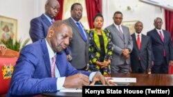 Kenya President William Ruto signs his controversial tax hike measure into law on Monday, June 26, 2023.