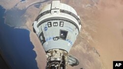 FILE - This photo provided by NASA shows the Starliner spacecraft docked to the Harmony module of the International Space Station, orbiting 262 miles above Egypt's Mediterranean coast, on June 13, 2024.