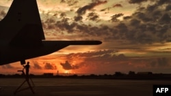 FILE - A German member of the European Naval Force performs technical checks on an anti-piracy reconnaissance plane as part of Operation Atalanta at a French military base in Djibouti, May 5, 2015.