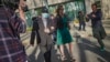 "Harry" Lu Jianwang, second from left, leaves Brooklyn federal court with his lawyer after his arraignment, April 17, 2023, in New York. Justice Dept. officials say Jianwang was arrested on charges that he helped establish a secret police outpost on behalf of the Chinese govt.