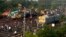 Onlookers are seen gathered as crews work at the site of a deadly train derailment in Balasore district, in the eastern Indian state of Odisha, June 4, 2023.