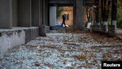 Broken windows are seen near a building damaged during a Russian drone strike in Kyiv, Ukraine, Sept. 10, 2023.