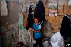 FILE - A Syrian refugee child works at a copper workshop in Gaziantep, Turkey, June 2, 2016.