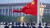 FILE - A Chinese honor guard unfurls the Chinese national flag in Beijing, Oct. 1, 2022. Several Western democracies are working to restart diplomatic engagement with China, while also defending their own countries' interests.