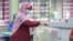 A voter casts her ballot at a polling station on the outskirts of Kuala Lumpur, Malaysia, Aug. 12, 2023. 
