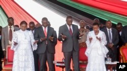 President William Ruto (center-right), First Lady Rachel Ruto (right), Deputy President Rigathi Gachagua (center-left) and his wife Dorcas Rigathi (left) pray during a national day of prayer event held at Nyayo stadium in the capital Nairobi, Kenya Tuesday, Feb. 14, 2023.