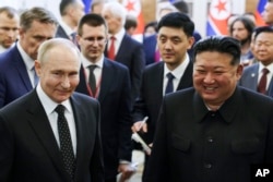 FILE - Russian President Vladimir Putin, left, and North Korea's leader Kim Jong Un smile as they walk after talks in Pyongyang, North Korea, June 19, 2024. (Kremlin photo via AP)