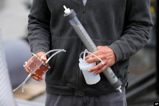 Dante Simonetti holds a small-scale model of technology called SeaChange on April 12, 2023, in San Pedro, Calif. (AP Photo/Ashley Landis)