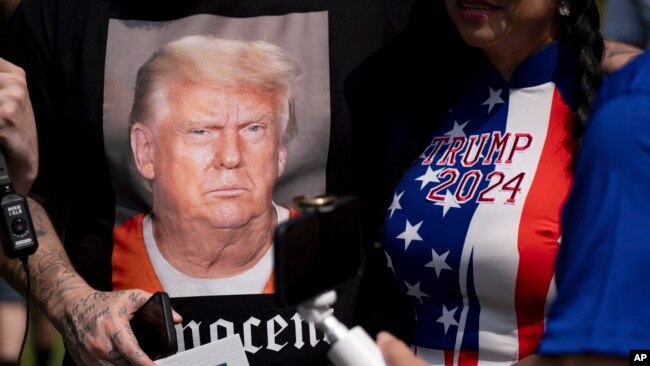 Supporters of former President Donald Trump and journalists gather in front of the Fulton County Jail in Atlanta, Aug. 24, 2023.