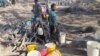 People drawing water from a drying well in Gwanda North