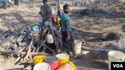 People drawing water from a drying well in Gwanda North