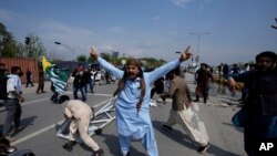 Supporters of former Prime Minister Imran Khan chant anti government slogans during clashes, in Islamabad, Pakistan, March 18, 2023.