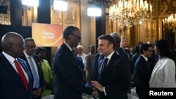 French President Emmanuel Macron, right, greets Rwanda's President Paul Kagame as he arrives to attend the Global Forum for Vaccine Sovereignty and Innovation at the French Foreign Ministry, the Quai d'Orsay, in Paris, France, June 20, 2024