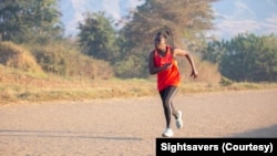 Taonere Banda runs on a track during training in Malawi in this undated photo. (Courtesy - Sightsavers)