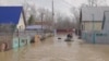 People row a boat in a flooded street in Orenburg, Russia, in this still image taken from video released, April 8, 2024. 