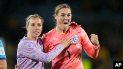 England's goalkeeper Mary Earps, right, and Jordan Nobbs celebrate as they won the Women's World Cup semifinal soccer match between Australia and England at Stadium Australia in Sydney, Australia, Aug. 16, 2023. 