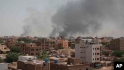 Smoke rises from a central neighborhood of Khartoum, Sudan, Sunday, April 16, 2023, after dozens have been killed in two days of intense fighting. (AP Photo/Marwan Ali)