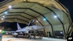 In this image provided on Jan. 12, 2024, by the UK Ministry of Defence, an RAF Typhoon aircraft returns to base at RAF Akrotiri in Cyprus, after striking targets in Yemen.
