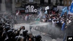 Police block an anti-government demonstration against food scarcity at soup kitchens and economic reforms proposed by President Javier Milei in Buenos Aires, Argentina. (AP Photo/Natacha Pisarenko)