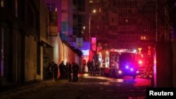 Emergency staff work at an apartment building damaged during a Russian drone strike, amid Russia's attack on Ukraine, in Kyiv, Dec. 22, 2023.