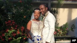 FILE - In this Nov. 9, 2018, photo provided by Nikese Toussaint, Jean-Dickens Toussaint and his wife, Abigail Michael Toussaint, pose for a photo at their wedding in Pompano Beach, Florida. 