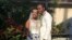 FILE - In this Nov. 9, 2018, photo provided by Nikese Toussaint, Jean-Dickens Toussaint and his wife, Abigail Michael Toussaint, pose for a photo at their wedding in Pompano Beach, Florida. 