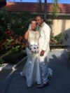 FILE - In this Nov. 9, 2018, photo provided by Nikese Toussaint, Jean-Dickens Toussaint and his wife, Abigail Michael Toussaint, pose for a photo at their wedding in Pompano Beach, Florida. 