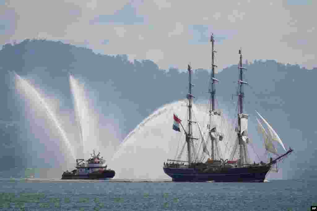 The Dutch tall ship Stad Amsterdam makes its way through San Francisco Bay followed by the fireboat St. Francis in this view from Sausalito, California, March 24, 2024. 