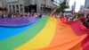 FILE - People carry a rainbow flag during the yearly Pride parade, known as the Equality Parade, in Warsaw, Poland, June 17, 2023. 