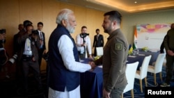 FILE - Ukraine's President Volodymyr Zelenskyy, right, and Indian Prime Minister Narendra Modi shake hands during the G7 leaders' summit in Hiroshima, Japan, May 20, 2023. (Ukrainian Presidential Press Service/Handout via Reuters)