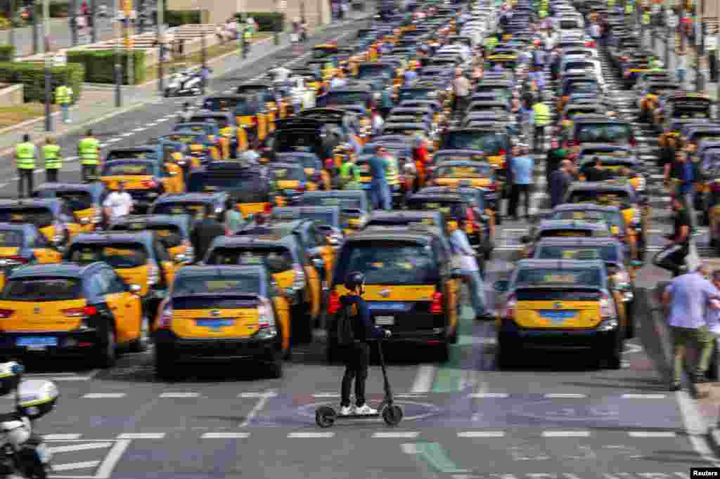 Taxi drivers protest after the Court of Justice of the European Union rejected rules set by the city of Barcelona that dramatically restrict the number of cars working with ride-hailing apps, in Barcelona, Spain.