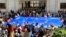 Protesters with a giant EU flag gather outside the parliament building in Tbilisi, Georgia, April 15, 2024, to protest against the "the Russian law" as it is similar to a law that Russia uses to stigmatize independent news media and organizations. 