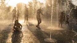 In this file photo, children play with water at a fountain during a heat wave, at Stavros Niarchos foundation Cultural Center in Athens, July 21, 2023. (AP Photo/Petros Giannakouris, File)