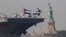 U.S. Sailors and Marines stand on the deck of the USS Bataan as it passes the Statue of Liberty during Fleet Week on in New York, May 22, 2024.