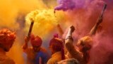 People sing, dance and throw colors at each other to celebrate Holi festival in Hyderabad, India, March 6, 2023. 