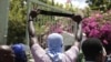 A protester holds up a machete as a symbol of self-defense against gangs, during a protest against insecurity in Port-au-Prince, Haiti, Aug. 25, 2023.