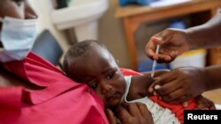 FILE: A nurse administers a different malaria vaccine to an infant at the Lumumba Sub-County hospital in Kisumu, Kenya, July 1, 2022.