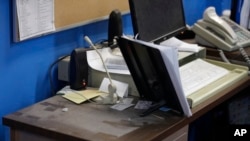 An empty spot on reporter Phyllis Zorn's desk shows where the tower for her computer sat before law enforcement officers seized it in a raid on the Marion County Record, Aug. 13, 2023, in Marion County, Kansas. 