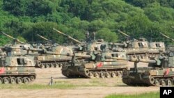 South Korean army soldiers work on their K-9 self-propelled howitzer in Paju, South Korea, near the border with North Korea, Aug. 19, 2024.