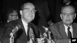 FILE - Chairman Newton Minow, left, of the Federal Communications Commission affirms prior to the Senate Foreign Relations Committee, Aug. 3, 1962, in Washington.