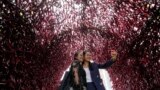 Women take a selfie inside a tunnel made with red peppers during H.O.T Festival at Seoul Plaza in Seoul, South Korea, Sept. 18, 2023.