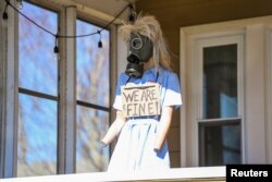 A mannequin is displayed near the site of the derailment of a train carrying hazardous waste in East Palestine, Ohio, Feb. 23, 2023.