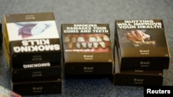 FILE - Mockups of cigarette packaging are shown in Ottawa, Ontario, May 31, 2016. In 2000, Canada became the first country to order graphic warnings on cigarette packages and in August 2023 will require warnings on individual cigarettes and cigars. 