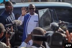 FILE - Chadian opposition leader Succes Masra (C) waves while arriving to a polling station to cast his vote during the constitutional referendum in N'Djamena, on Dec. 17, 2023.