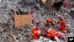 In this photo released by Xinhua News Agency, rescuers carry out operations in Liangshui Village, Tangfang Town, Zhenxiong County, southwest China's Yunnan Province, Jan. 24, 2024. 