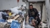 A man salvages food packages from a building that was hit overnight during Israeli bombardment in Rafah in the southern Gaza Strip, March 26, 2024.