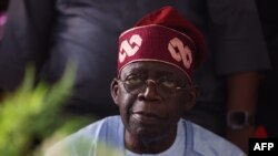 FILE: Presidential candidate Bola Tinubu looks on in Abuja on March 1, 2023 during celebrations at his campaign headquarters. Tinubu's win is being challenged by six opposition-dominated Nigerian states.